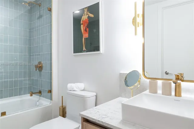 a bathroom with a shower a sink and mirror