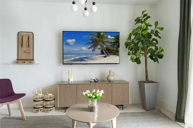a vase of flowers sitting on a table with a potted plant