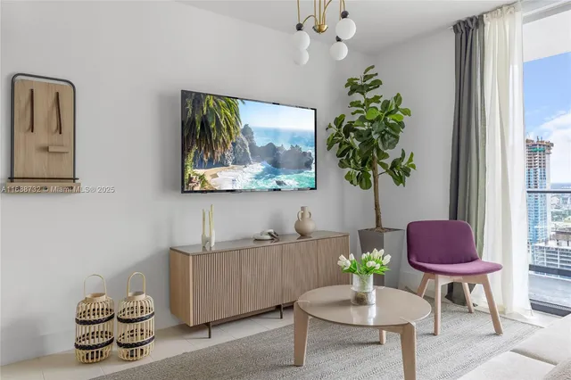 a living room with furniture and a potted plant