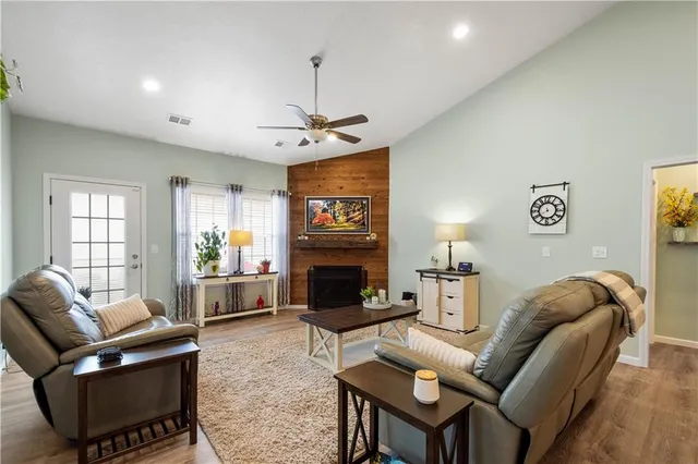a living room with furniture a fireplace and a chandelier