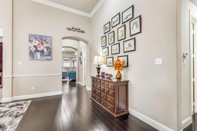 a view of a hallway with wooden floor and furniture