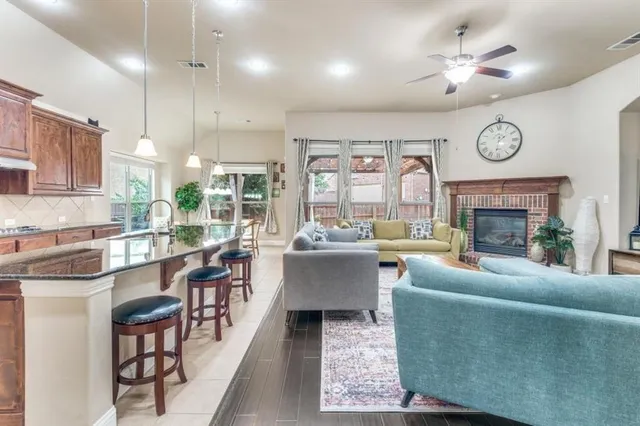 a living room with furniture a fireplace a clock and a large window