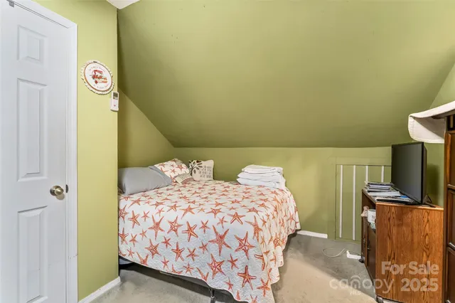 a bedroom with two bed and a flat screen tv