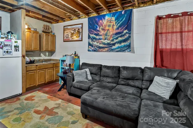 a living room with furniture and a painting on the wall