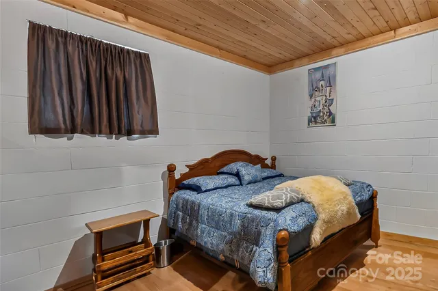 a bedroom with a bed and a wall