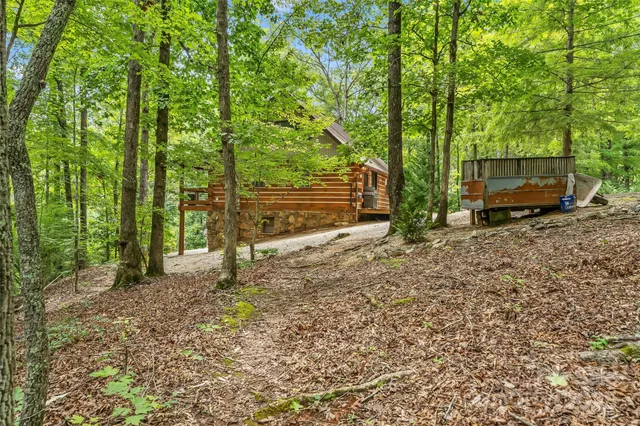 a backyard of a house with wooden floor and outdoor seating
