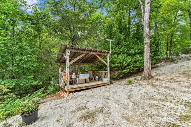 a view of a house with backyard and sitting area