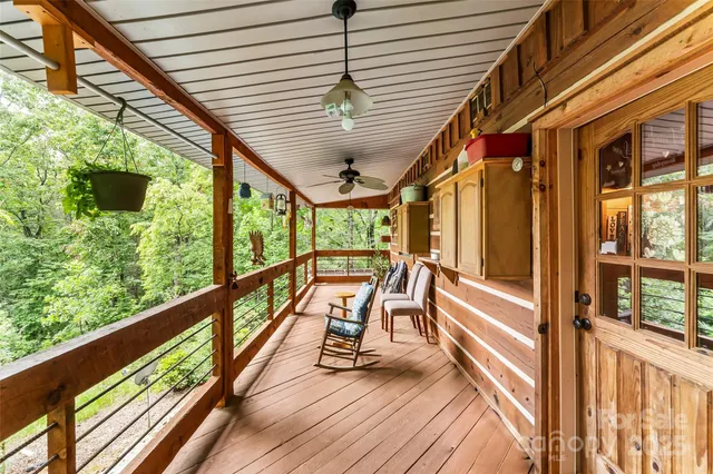 a view of balcony with wooden floor and furniture
