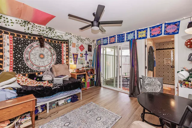 a living room with furniture a wooden floor and a chandelier