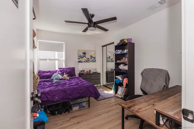 a bedroom with bed and a bookshelf