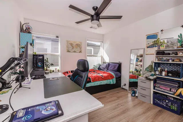 a living room with furniture a flat screen tv and a window