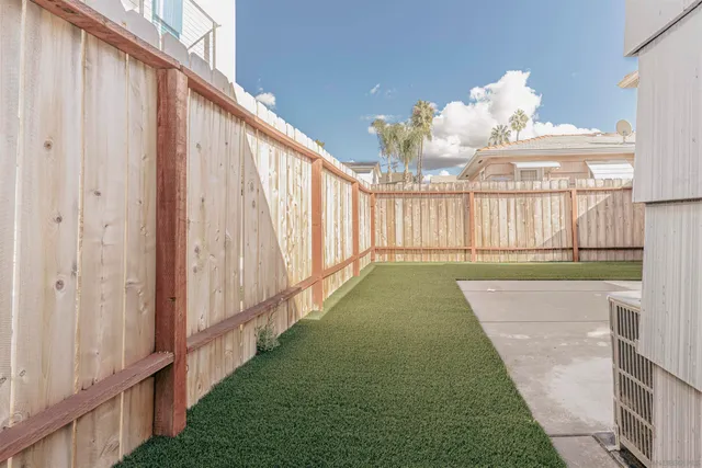 a view of a porch with furniture and floor to ceiling window
