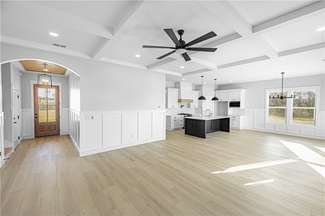 1296 Hebron Church Road Iva, SC 29655 - Photo 14 of 37 This bright and airy open-concept space features high ceilings and elegant flooring, connecting living, dining, and kitchen areas.