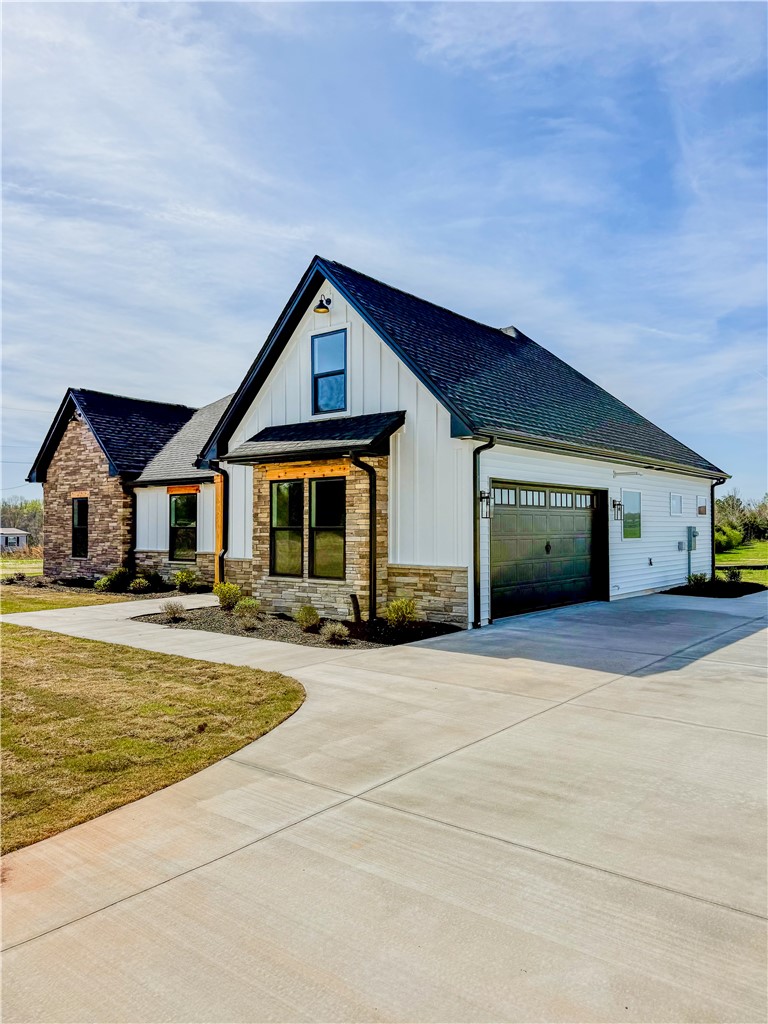 1296 Hebron Church Road Iva, SC 29655 - Photo 2 of 37 This modern farmhouse features a blend of textures, a spacious driveway, and lush landscaping.