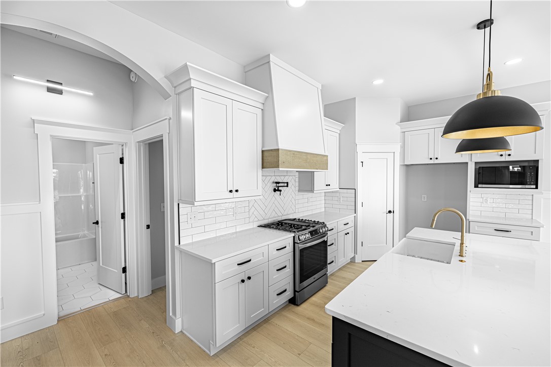 1296 Hebron Church Road Iva, SC 29655 - Photo 21 of 37 This modern kitchen features a spacious island and white cabinetry, perfect for entertaining.