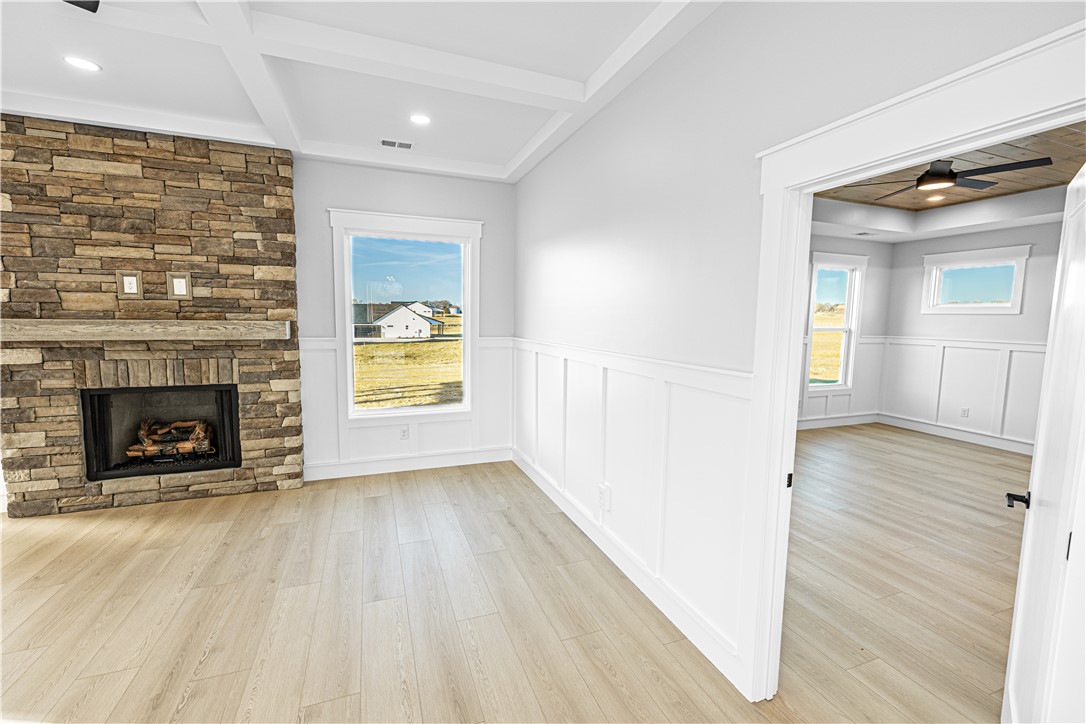 1296 Hebron Church Road Iva, SC 29655 - Photo 24 of 37 This bright interior features a warm stone fireplace, natural light, and elegant wainscoting.