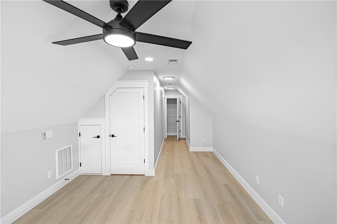 1296 Hebron Church Road Iva, SC 29655 - Photo 25 of 37 This spacious attic room features bright lighting and durable flooring, perfect for versatile living.