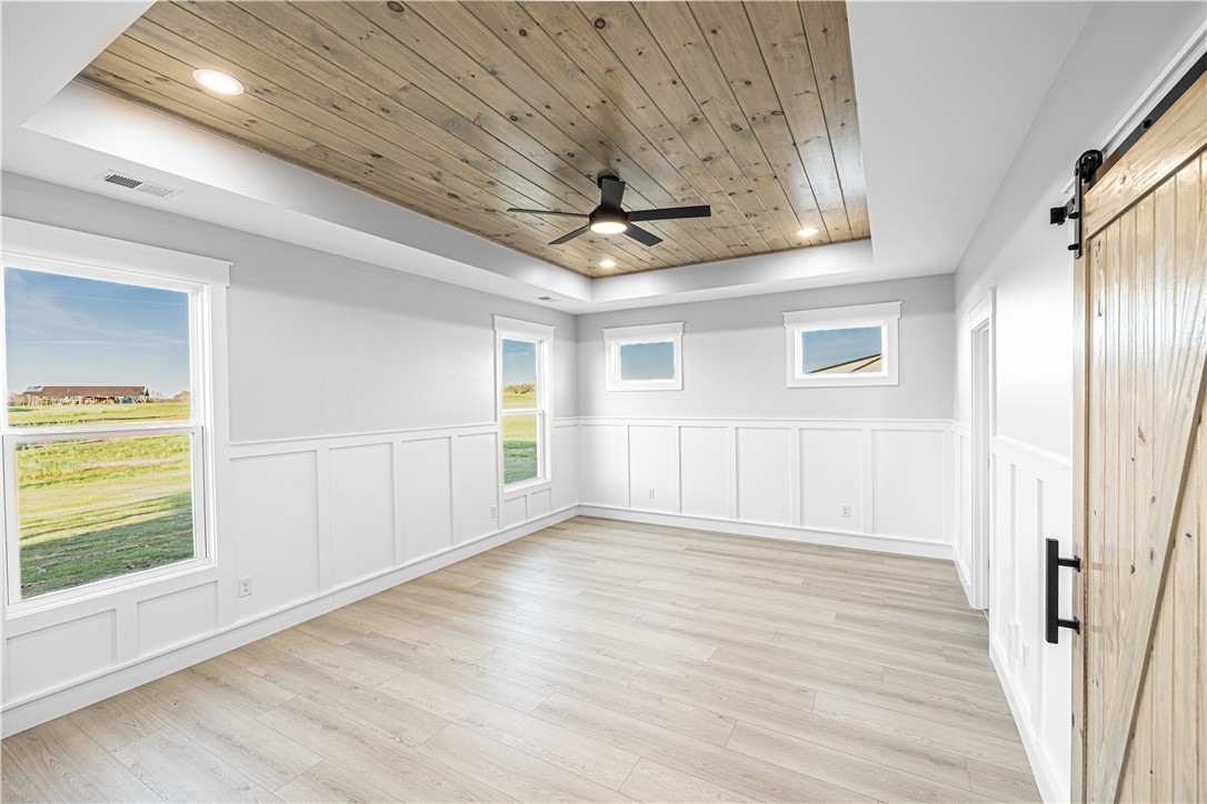 1296 Hebron Church Road Iva, SC 29655 - Photo 26 of 37 This bright space features a wooden tray ceiling and durable flooring, perfect for versatile living.