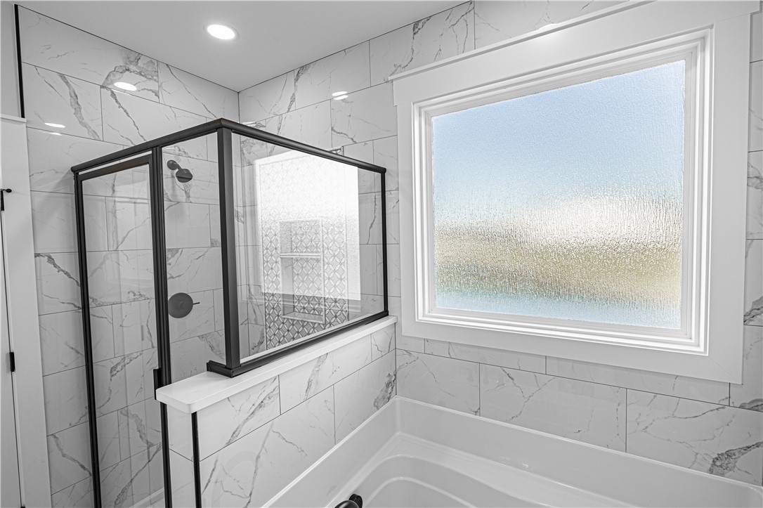 1296 Hebron Church Road Iva, SC 29655 - Photo 27 of 37 This bathroom features a contemporary shower and a window above the soaking tub.