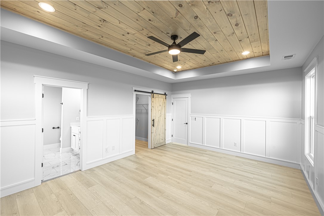 1296 Hebron Church Road Iva, SC 29655 - Photo 29 of 37 This spacious bedroom features a captivating wood plank ceiling and elegant panel molding.