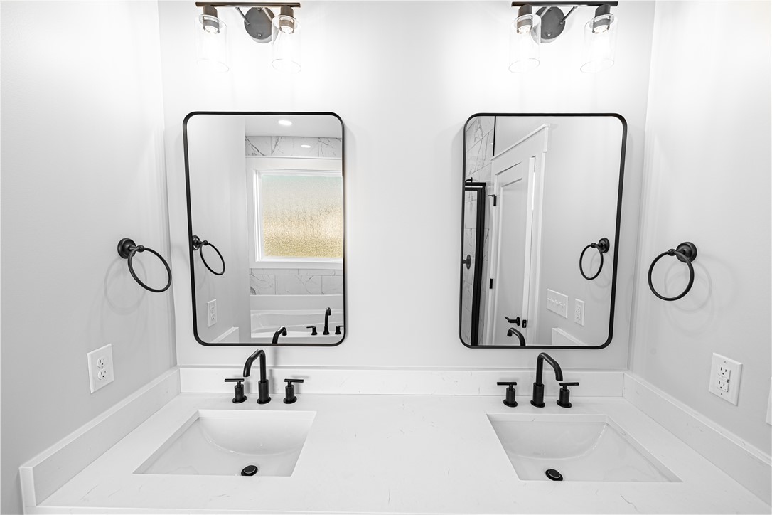 1296 Hebron Church Road Iva, SC 29655 - Photo 3 of 37 This modern bathroom features a double vanity, offering convenience and a sleek aesthetic.