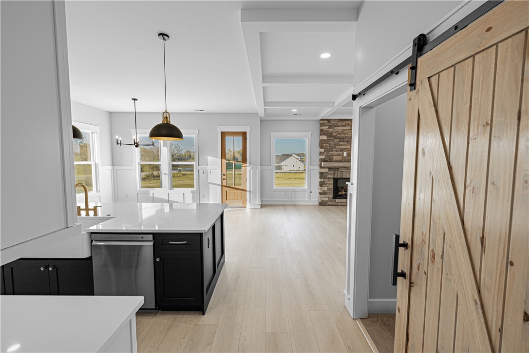 1296 Hebron Church Road Iva, SC 29655 - Photo 34 of 37 This bright and airy open-concept space features a well-appointed kitchen, fireplace, and barn door.