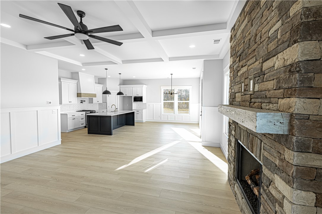 1296 Hebron Church Road Iva, SC 29655 - Photo 35 of 37 This expansive open-concept living space features a cozy fireplace, seamlessly connecting the kitchen and living areas.