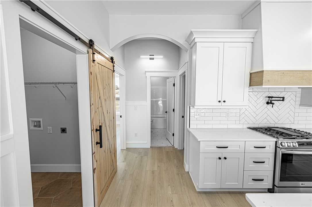 1296 Hebron Church Road Iva, SC 29655 - Photo 36 of 37 This modern home features sleek white cabinetry and natural wood tones, creating a bright and inviting atmosphere.