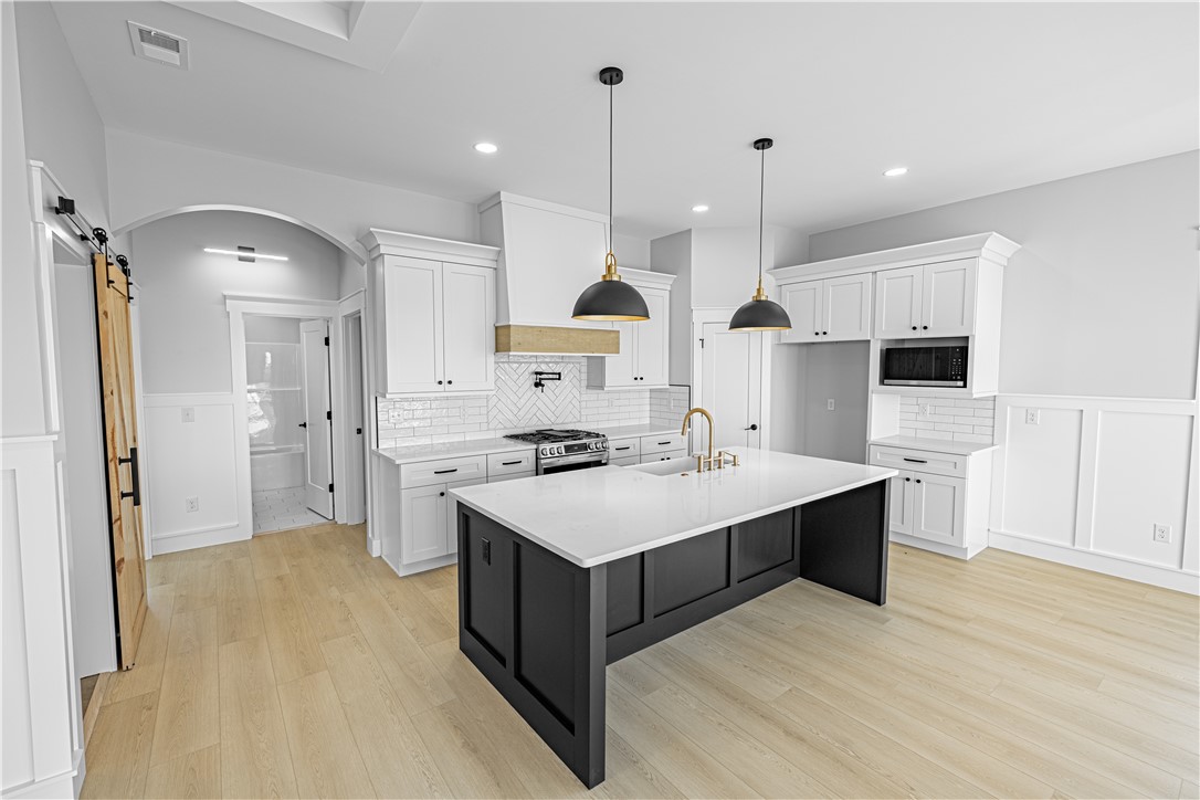 1296 Hebron Church Road Iva, SC 29655 - Photo 37 of 37 This bright and open kitchen features an expansive island and contemporary fixtures, perfect for modern living.