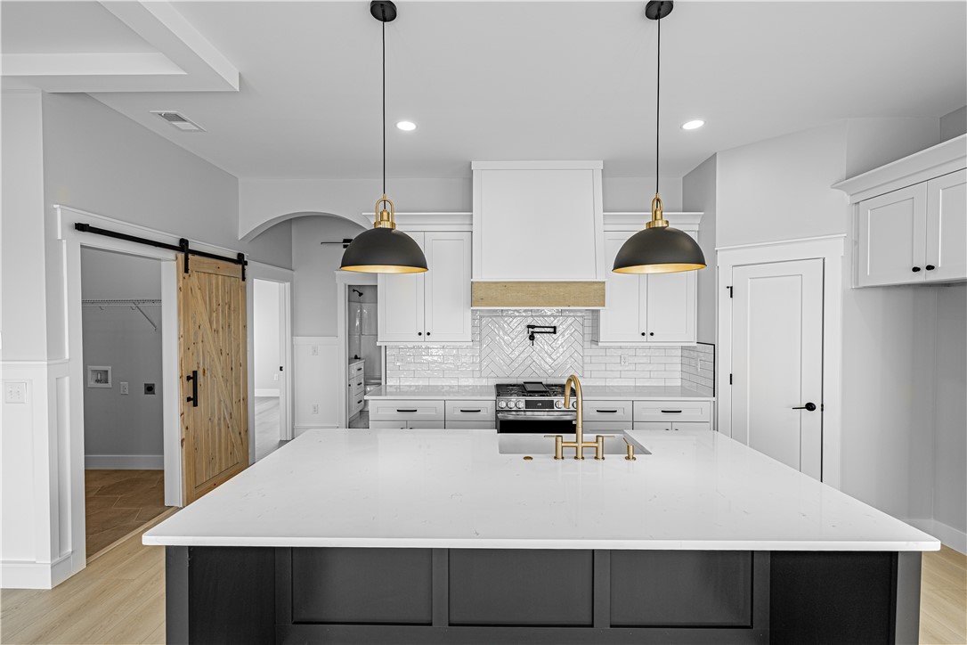 1296 Hebron Church Road Iva, SC 29655 - Photo 5 of 37 This modern kitchen features a large island and ample storage, creating a functional cooking space.