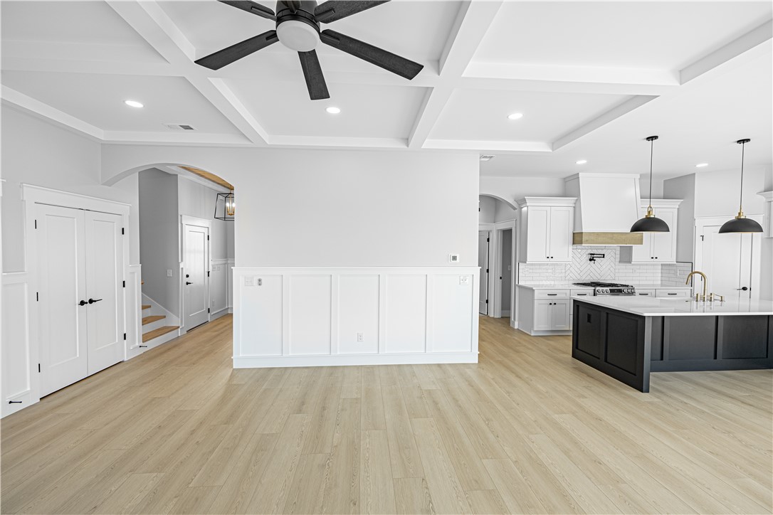 1296 Hebron Church Road Iva, SC 29655 - Photo 7 of 37 This bright, open-concept living space boasts coffered ceilings, recessed lighting, and a modern kitchen with an island.