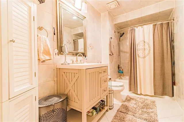 a bathroom with a sink a toilet and shower curtain