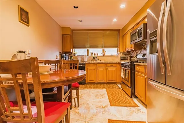 a kitchen with stainless steel appliances kitchen island granite countertop a sink and cabinets