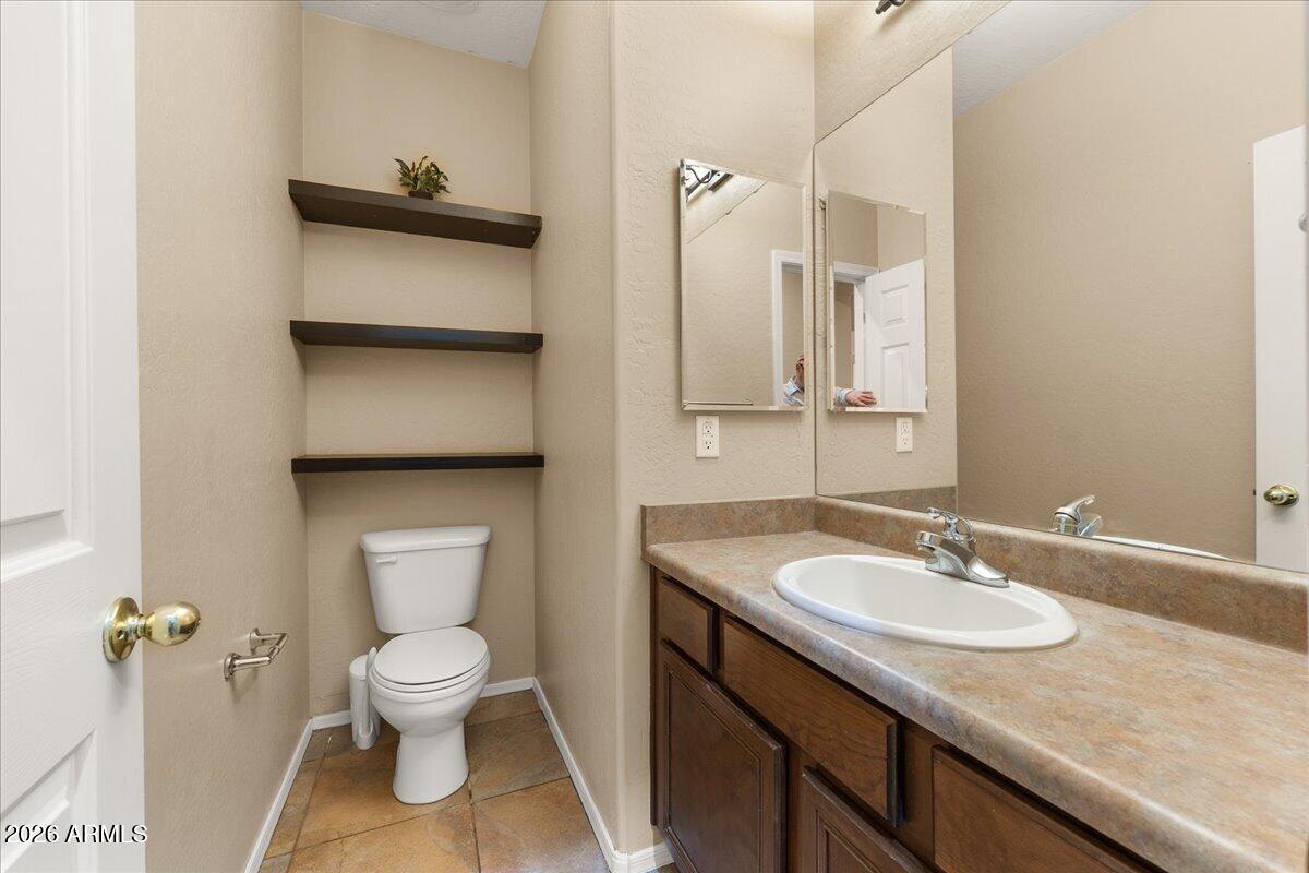 813 Alfonse Road Clarkdale, AZ 86324 - Photo 25 of 41 a bathroom with a granite countertop sink toilet and shower