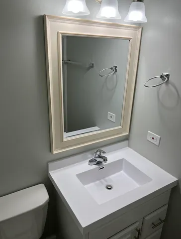 a bathroom with a sink vanity and a mirror
