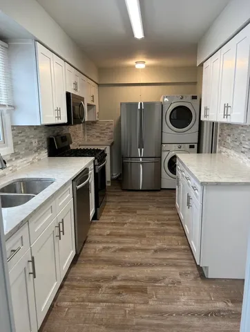 a kitchen with a sink a stove and refrigerator
