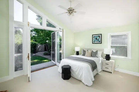 a bathroom with a sink and mirror with window