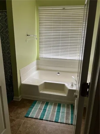 a bathroom with a tub and a window