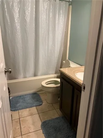 a bathroom with a granite countertop bathtub and toilet