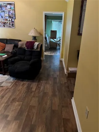 a living room with furniture and a mirror