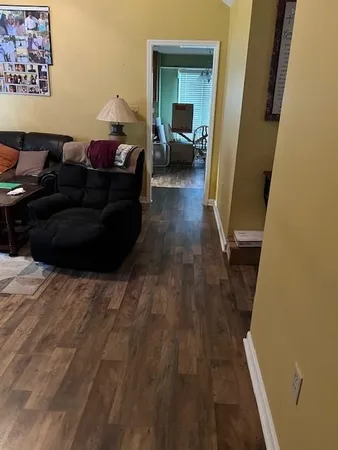 a living room with furniture and a mirror