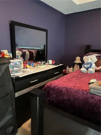 a bedroom with two beds and a mirror