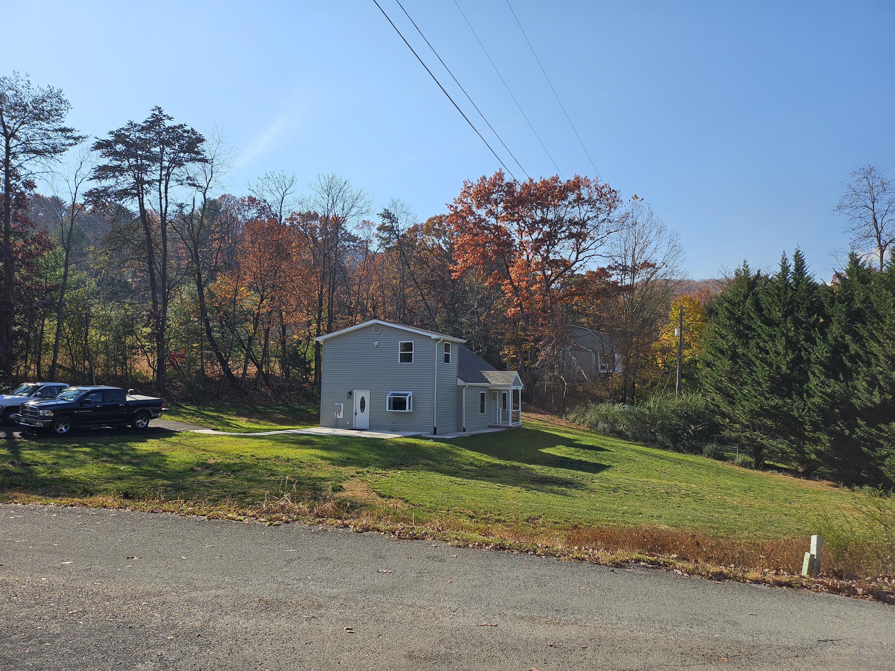 4443 Keefer Road Roanoke, VA 24018 - Photo 4 of 26 a view of a tiny house with a big yard and a large trees