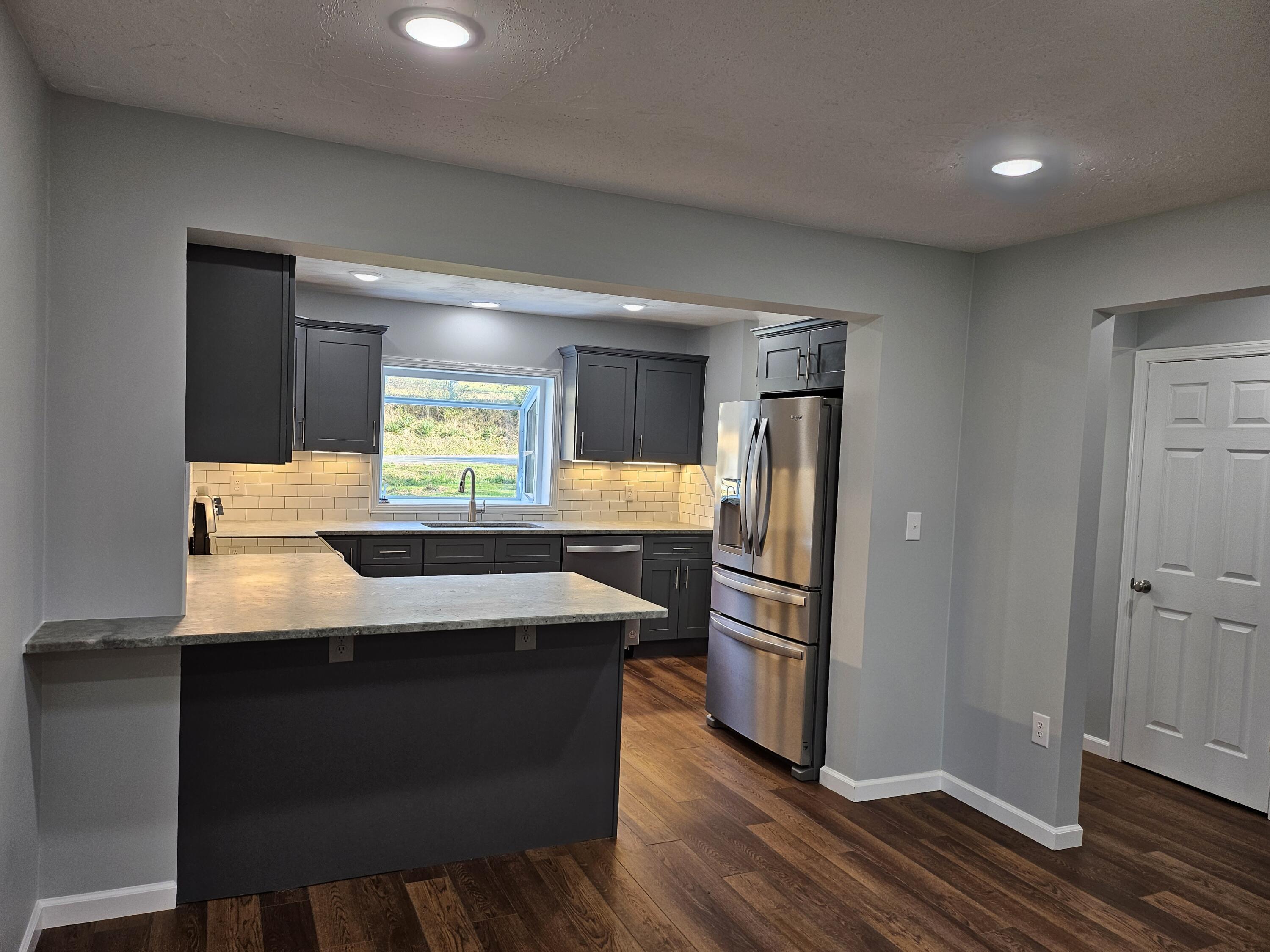 4443 Keefer Road Roanoke, VA 24018 - Photo 7 of 26 a kitchen with granite countertop a sink cabinets and stainless steel appliances
