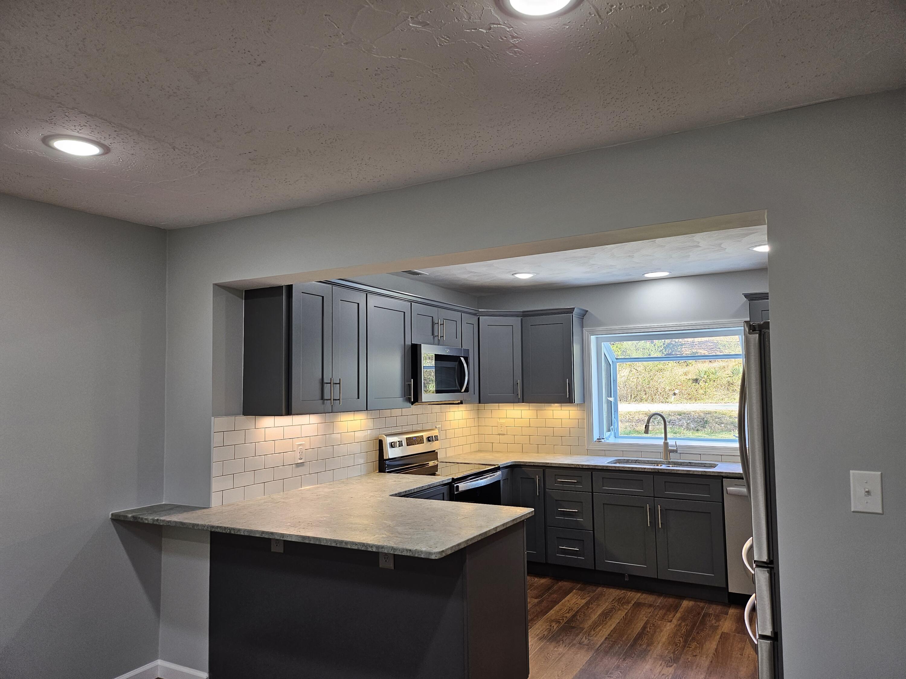 4443 Keefer Road Roanoke, VA 24018 - Photo 8 of 26 a kitchen with a sink cabinets and window