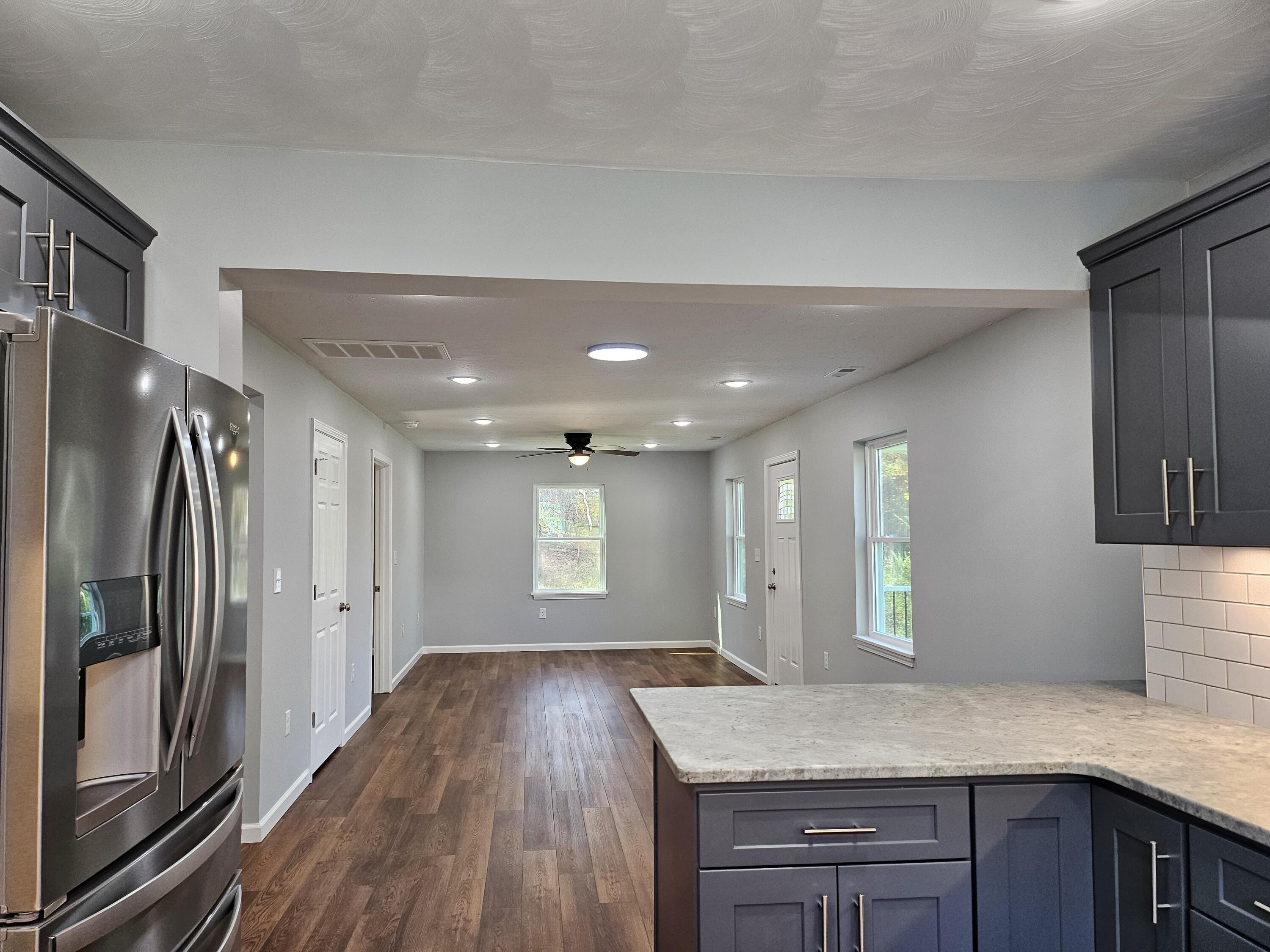 4443 Keefer Road Roanoke, VA 24018 - Photo 9 of 26 a view of a kitchen island a sink and wooden floor