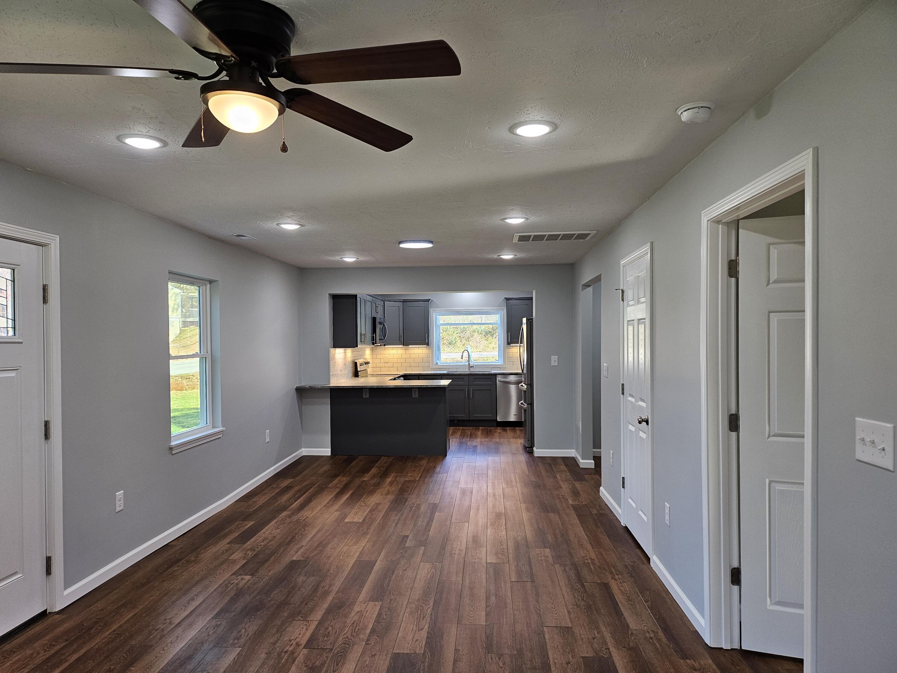 4443 Keefer Road Roanoke, VA 24018 - Photo 10 of 26 an empty room with wooden floor ceiling fan and windows