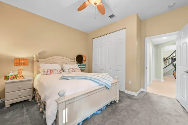 a bedroom with furniture and a large window