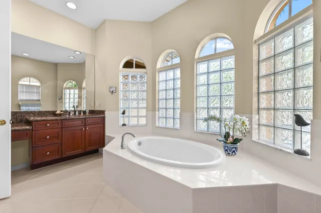 a living room with furniture a flat screen tv and a large window