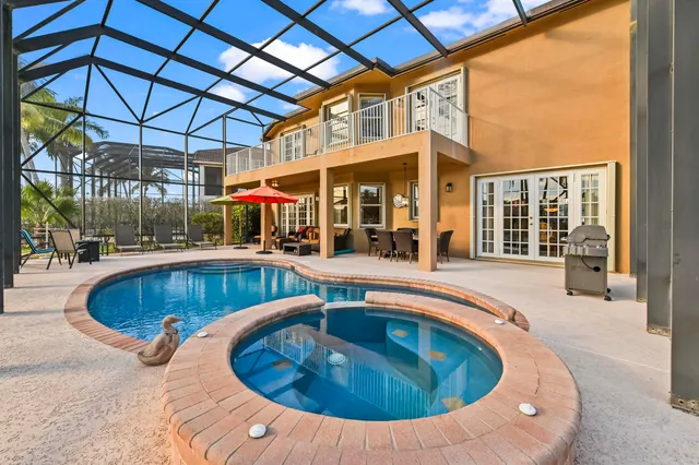 an aerial view of house with yard and lake view